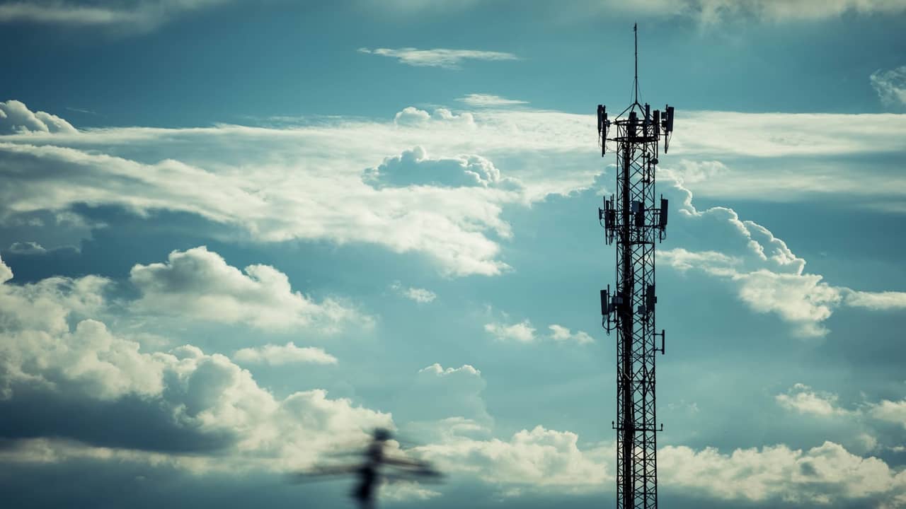 Smartphone satellite connectivity illustrated beside a Starlink dish — Direct-to-Cell vs broadband in Nigeria