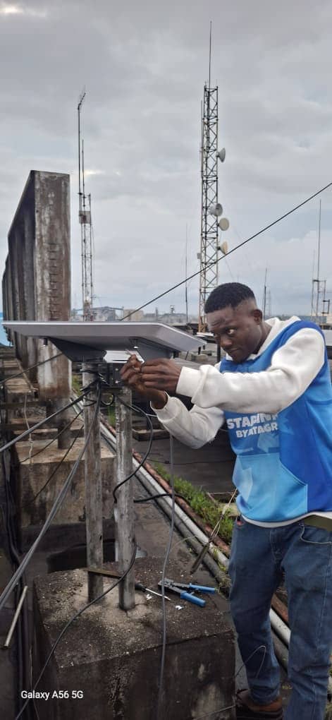 DataGram technician mounting a Starlink dish on a Nigerian rooftop