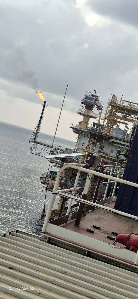 Starlink maritime installation on an offshore platform with flare stack and open sea